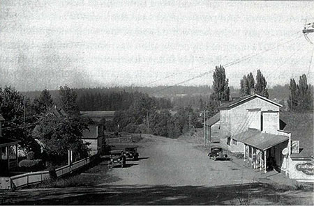 1938 photo looking north past the Butteville Store. Note the overgrown road leading down to the landing [Photo from Willamette Landings by Howard M. Corning]